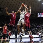 
              Purdue's Zach Edey (15) grabs a rebound against Wisconsin's Jordan Davis (2) and Chris Vogt (33) during the second half of an NCAA basketball game, Monday, Jan. 3, 2022, in West Lafayette, Ind. (AP Photo/Darron Cummings)
            