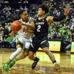 
              Oregon guard Jacob Young (42) is guarded by Colorado guard KJ Simpson (2) as he drives the lane during the first half of an NCAA college basketball game Tuesday, Jan. 25, 2022, in Eugene, Ore. (AP Photo/Andy Nelson)
            