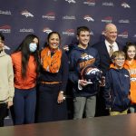 
              From left, Denver Broncos general manager George Paton, his son Beau, 13, daughter Bella, 15, and wife Barb join the family of new Broncos head coach Nathaniel Hackett, six from left, and his children Harrison, 13, London, 11, Briar, 12, Everly, 9, and wife Megan for a photograph after a news conference Friday, Jan. 28, 2022, at the NFL football team's headquarters in Englewood, Colo. (AP Photo/David Zalubowski)
            