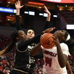 
              Wake Forest guard Elise Williams, left, tries to block the shot of Louisville forward Olivia Cochran (44) during the second half of an NCAA college basketball game in Louisville, Ky., Sunday, Jan. 23, 2022. (AP Photo/Timothy D. Easley)
            
