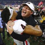 
              Georgia head coach Kirby Smart celebrates winning the College Football Playoff Championship game against Alabama, getting a hoist from outside linebacker Bolan Smith, early Tuesday, Jan. 11, 2022, in Indianapolis. (Curtis Compton/Atlanta Journal-Constitution via AP)
            