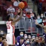 
              Ohio State guard Jamari Wheeler, left, goes up to shoot in front of Northwestern guard Boo Buie during the first half of an NCAA college basketball game in Columbus, Ohio, Sunday, Jan. 9, 2022. (AP Photo/Paul Vernon)
            