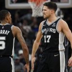 
              San Antonio Spurs guard Dejounte Murray (5) and forward Doug McDermott (17) celebrate a score against the Oklahoma City Thunder during the second half of an NBA basketball game, Wednesday, Jan. 19, 2022, in San Antonio. (AP Photo/Eric Gay)
            