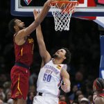 
              Cleveland Cavaliers forward Evan Mobley (4) dunks over Oklahoma City Thunder forward Jeremiah Robinson-Earl (50) in the second half of an NBA basketball game Saturday, Jan. 15, 2022, in Oklahoma City. (AP Photo/Nate Billings)
            