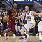 
              Cleveland Cavaliers guard Darius Garland (10) drives past Golden State Warriors guard Stephen Curry (30) during the first half of an NBA basketball game in San Francisco, Sunday, Jan. 9, 2022. (AP Photo/John Hefti)
            