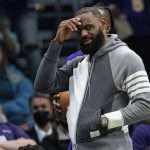 
              Los Angeles Lakers forward LeBron James looks on during the first half of an NBA basketball game against the Charlotte Hornets in Charlotte, N.C., Friday, Jan. 28, 2022. (AP Photo/Jacob Kupferman)
            