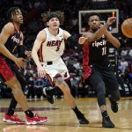 
              Portland Trail Blazers guard Dennis Smith Jr. (10) passes the ball as Miami Heat guard Kyle Guy (5) defends during the first half of an NBA basketball game, Wednesday, Jan. 19, 2022, in Miami. At left is Portland Trail Blazers forward Trendon Watford (2). (AP Photo/Lynne Sladky)
            