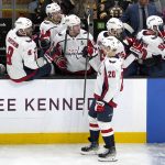 
              Washington Capitals center Lars Eller (20) is congratulated along the bench after scoring a goal during the second period of an NHL hockey game against the Boston Bruins, Thursday, Jan. 20, 2022, in Boston. (AP Photo/Mary Schwalm)
            