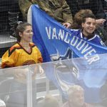 
              Vancouver Canucks fans cheer during the first period of an NHL hockey game against the Seattle Kraken, Saturday, Jan. 1, 2022, in Seattle. (AP Photo/Ted S. Warren)
            