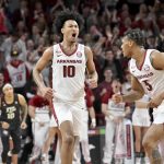 
              Arkansas forward Jaylin Williams (10) celebrates with teammate Au'Diese Toney (5) after making a basket against Texas A&M during the first overtime period of an NCAA college basketball game Saturday, Jan. 22, 2022, in Fayetteville, Ark. (AP Photo/Michael Woods)
            