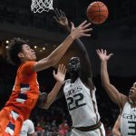 
              Syracuse center Jesse Edwards, left, passes past Miami forward Deng Gak (22) and guard Charlie Moore (3) during the first half of an NCAA college basketball game, Wednesday, Jan. 5, 2022, in Coral Gables, Fla. (AP Photo/Wilfredo Lee)
            