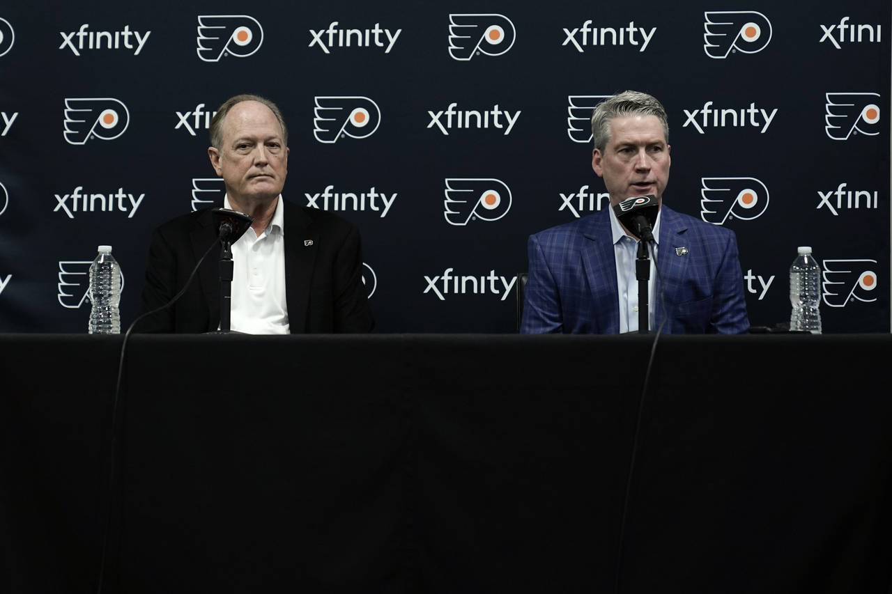 Philadelphia Flyers chairman Dave Scott, left, and Flyers general manager Chuck Fletcher take part ...