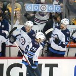 
              Winnipeg Jets' Blake Wheeler (26) returns to his bench after scoring during the first period of an NHL hockey game against the Pittsburgh Penguins in Pittsburgh, Sunday, Jan. 23, 2022. (AP Photo/Gene J. Puskar)
            
