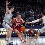 
              Wisconsin guard Brad Davison, center, drives to the basket against Northwestern forward Robbie Beran, left, and guard Ty Berry during the first half of an NCAA college basketball game in Evanston, Ill., Tuesday, Jan. 18, 2022. (AP Photo/Nam Y. Huh)
            