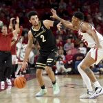 
              Vanderbilt guard Scotty Pippen Jr. (2) tries to get past Arkansas guard Au'Diese Toney (5) during the second half of an NCAA college basketball game Tuesday, Jan. 4, 2022, in Fayetteville, Ark. (AP Photo/Michael Woods)
            