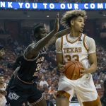 
              Texas forward Tre Mitchell, right, looks to pass against Oklahoma State forward Moussa Cisse, left, during the first half of an NCAA college basketball game, Saturday, Jan. 22, 2022, in Austin, Texas. (AP Photo/Michael Thomas)
            