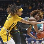 
              Baylor forward NaLyssa Smith (1) is defended by West Virginia forward Esmery Martinez (12) during the first half of an NCAA college basketball game in Morgantown, W.Va., Saturday, Jan. 29, 2022. (AP Photo/Kathleen Batten)
            