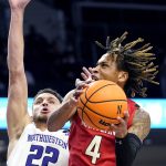 
              Maryland guard Fatts Russell, right, drives to the basket against Northwestern forward Pete Nance during the first half of an NCAA college basketball game in Evanston, Ill., Wednesday, Jan. 12, 2022. (AP Photo/Nam Y. Huh)
            
