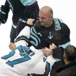 Seattle Kraken's Mark Giordano, right, grabs San Jose Sharks' Adam Raska as they tussle in the second period of an NHL hockey game Thursday, Jan. 20, 2022, in Seattle. (AP Photo/Elaine Thompson)