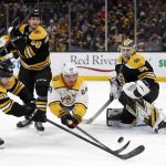 
              Nashville Predators' Mikael Granlund dives for a loose puck in front of Boston Bruins goaltender Linus Ullmark with defenseman Tyler Lewington, left, during the second period of an NHL hockey game Saturday, Jan. 15, 2022, in Boston. (AP Photo/Winslow Townson)
            