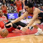 
              Washington Wizards guard Tremont Waters, right, reaches for the loose ball against Chicago Bulls forward DeMar DeRozan (11) during the first half of an NBA basketball game, Saturday, Jan. 1, 2022, in Washington. (AP Photo/Nick Wass)
            