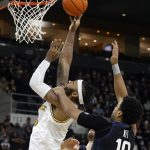 
              Providence center Nate Watson (0) shoots ahead of Butler forward Bryce Nze (10) during the first half of an NCAA college basketball game, Sunday, Jan. 23, 2022, in Providence, R.I. (AP Photo/Mary Schwalm)
            
