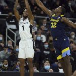 
              Marquette's Darryl Morsell (32) attempts to block a shot by Providence's Al Durham (1) during the first half of an NCAA college basketball game Sunday, Jan. 30, 2022, in Providence, R.I. (AP Photo/Stew Milne)
            