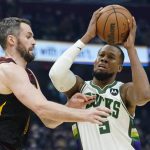 
              Milwaukee Bucks' Rodney Hood (5) drives against Cleveland Cavaliers' Kevin Love (0) in the first half of an NBA basketball game, Wednesday, Jan. 26, 2022, in Cleveland. (AP Photo/Tony Dejak)
            