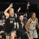 
              Providence forward Noah Horchler (14) gestures after he made a three-point basket during the second half of an NCAA college basketball game next to Georgetown forward Jalin Billingsley (4), Sunday, Feb. 6, 2022, in Washington. Providence won 71-52. (AP Photo/Nick Wass)
            