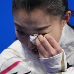 
              Kaori Sakamoto, of Japan, reacts after the women's short program during the figure skating at the 2022 Winter Olympics, Tuesday, Feb. 15, 2022, in Beijing. (AP Photo/Natacha Pisarenko)
            