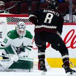 
              Arizona Coyotes center Nick Schmaltz (8) scores a goal against Dallas Stars goaltender Jake Oettinger (29) during the second period of an NHL hockey game Sunday, Feb. 20, 2022, in Glendale, Ariz. (AP Photo/Ross D. Franklin)
            