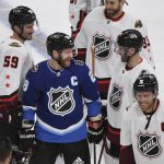 
              Metropolitan Division's Claude Giroux, of the Philadelphia Flyers, middle, smiles after the Metropolitan Division defeated the Central Division in the NHL All-Star hockey game final Saturday, Feb. 5, 2022, in Las Vegas. (AP Photo/Sam Morris)
            