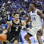 
              Vanderbilt's Scotty Pippen Jr. (2) drives while defended by Kentucky's Oscar Tshiebwe (34) during the second half of an NCAA college basketball game in Lexington, Ky., Wednesday, Feb. 2, 2022. Kentucky won 77-70. (AP Photo/James Crisp)
            