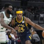 
              Indiana Pacers guard Buddy Hield (24) goes to the basket against Boston Celtics guard Jaylen Brown (7) during the first half of an NBA basketball game, Sunday, Feb. 27, 2022, in Indianapolis. (AP Photo/Darron Cummings)
            