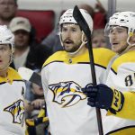 
              Nashville Predators left wing Filip Forsberg, center, celebrates his goal against the Carolina Hurricanes with center Mikael Granlund, left, and left wing Tanner Jeannot (84) during the third period of an NHL hockey game Friday, Feb. 18, 2022, in Raleigh, N.C. (AP Photo/Chris Seward)
            