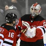 
              New Jersey Devils goaltender Nico Daws (50) celebrates with left wing Jimmy Vesey (16) after the Devils defeated the Vancouver Canucks 7-2 in an NHL hockey game Monday, Feb. 28, 2022, in Newark, N.J. (AP Photo/Bill Kostroun)
            