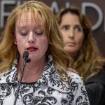 
              Survivor Kara Cagle, foreground, speaks as fellow survivor Julie Wallach, background, reaches out to comfort her during a news conference to announce a $243-million settlement in the UCLA sex abuse case of former UCLA gynecologist/oncologist James Heaps, at the law offices of Manly, Stewart & Finaldi in Irvine, Calif., Tuesday, Feb. 8, 2022. (Leonard Ortiz/The Orange County Register via AP)
            