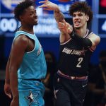 
              Team Payton's LaMelo Ball, of the Charlotte Hornets, passes the ball away from Team Barry's Jae'Sean Tate, of the Houston Rockets, during a semifinal of the NBA basketball Rising Stars event Friday, Feb. 18, 2022, in Cleveland. (AP Photo/Ron Schwane)
            