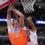 
              Oklahoma City Thunder center Aleksej Pokusevski, left, shoots against Chicago Bulls forward Tyler Cook during the first half of an NBA basketball game in Chicago, Saturday, Feb. 12, 2022. (AP Photo/Nam Y. Huh)
            