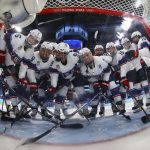 
              United States players gather in front of the net before a preliminary round women's hockey game against Finland at the 2022 Winter Olympics, Thursday, Feb. 3, 2022, in Beijing. (Jonathan Ernst/Pool Photo via AP)
            