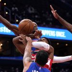 
              Washington Wizards forward Rui Hachimura, middle, is defended by Detroit Pistons during the first half of an NBA basketball game, Monday, Feb. 14, 2022, in Washington. (AP Photo/Evan Vucci)
            