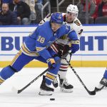 
              Chicago Blackhawks left wing Dominik Kubalik (8) and St. Louis Blues center Robert Thomas (18) vie for the puck during the first period of an NHL hockey game Saturday, Feb. 12, 2022, in St. Louis. (AP Photo/Joe Puetz)
            