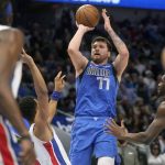
              Dallas Mavericks guard Luka Doncic (77) shoots against the Detroit Pistons during the first quarter of an NBA basketball game in Dallas, Tuesday, Feb. 8, 2022. (AP Photo/LM Otero)
            