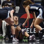 
              Villanova's Bella Runyan, center, reacts to being fouled with teammates Villanova's Brianna Herlihy, left, and Villanova's Maddy Siegrist, right, in the first half of an NCAA college basketball game against Connecticut, Wednesday, Feb. 9, 2022, in Hartford, Conn. (AP Photo/Jessica Hill)
            