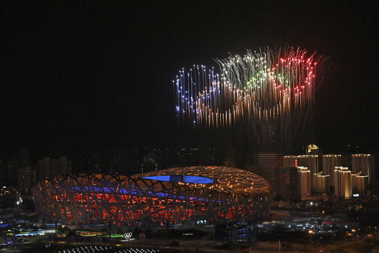 Fireworks, forming the Olympic rings, illuminate the sky during the opening ceremony of the 2022 Wi...