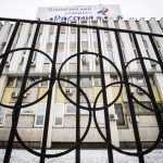 
              The building of the Russian Olympic Committee is seen through a gate decorated with the Olympic rings, in Moscow, on Dec. 6, 2017. Doping and other controversies involving Russian athletes have played a significant role at the Games for over a decade. (AP Photo/Alexander Zemlianichenko, File)
            