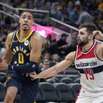 
              Indiana Pacers' Tyrese Haliburton (0) goes to the basket against Washington Wizards' Raul Neto (19) during the first half of an NBA basketball game, Wednesday, Feb. 16, 2022, in Indianapolis. Indiana won 113-108. (AP Photo/Darron Cummings)
            