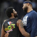 
              Brooklyn Nets guard Kyrie Irving, left, greets Denver Nuggets center DeMarcus Cousins as they warm up before an NBA basketball game Sunday, Feb. 6, 2022, in Denver. (AP Photo/David Zalubowski)
            