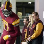 
              Dan and Tanya Snyder, co-owners and co-CEOs of the Washington Commanders and and former quarterback Joe Theismann, right, unveil their NFL football team's new identity, Wednesday, Feb. 2, 2022, in Landover, Md. The new name comes 18 months after the once-storied franchise dropped its old moniker following decades of criticism that it was offensive to Native Americans. (AP Photo/Patrick Semansky)
            