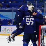 
              Finland's Marko Anttila (12) jumps on Atte Ohtamaa (55) and goalkeeper Harri Sateri after Finland beat Russian Olympic Committee to win the men's gold medal hockey game at the 2022 Winter Olympics, Sunday, Feb. 20, 2022, in Beijing. (AP Photo/Matt Slocum)
            